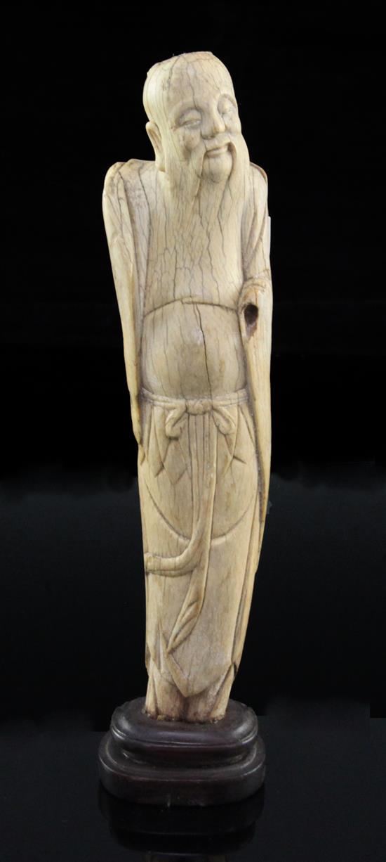 A Chinese ivory figure of an immortal, late Ming dynasty, height 21cm, slight losses and age cracks